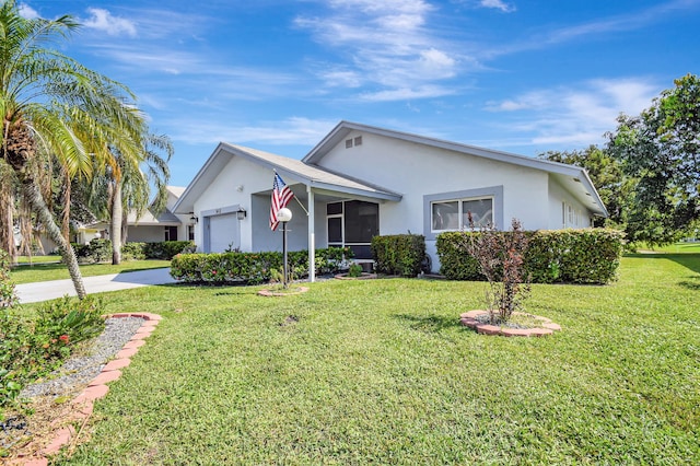 ranch-style house featuring a front yard and a garage