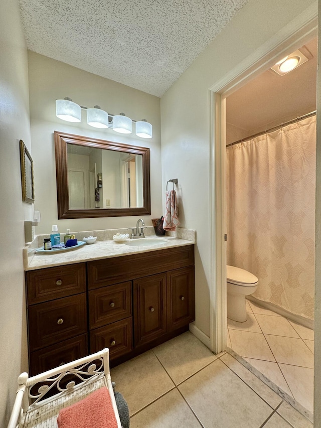 full bath featuring vanity, toilet, tile patterned floors, a textured ceiling, and curtained shower