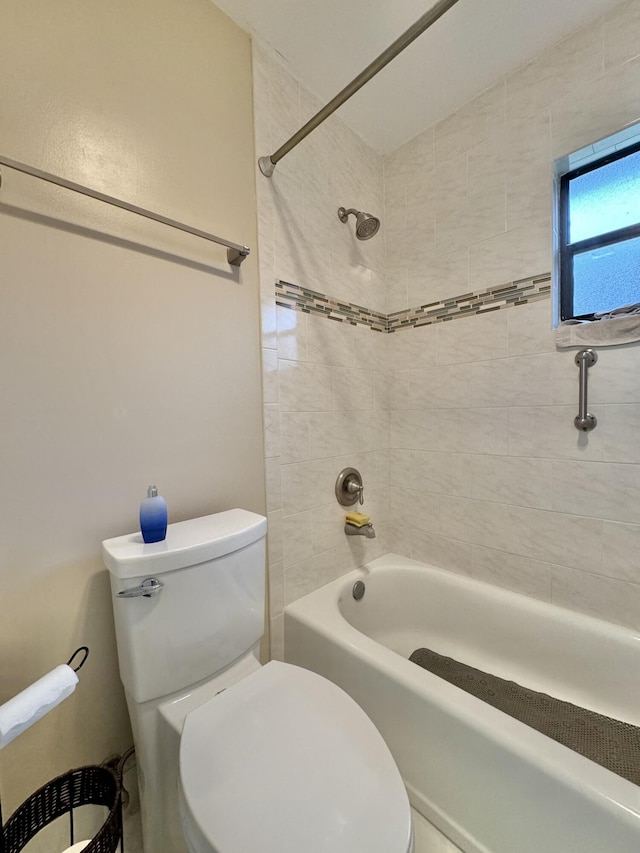 bathroom featuring washtub / shower combination and toilet