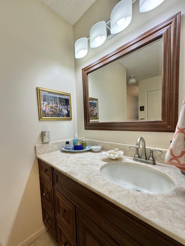 bathroom with vanity and a textured ceiling