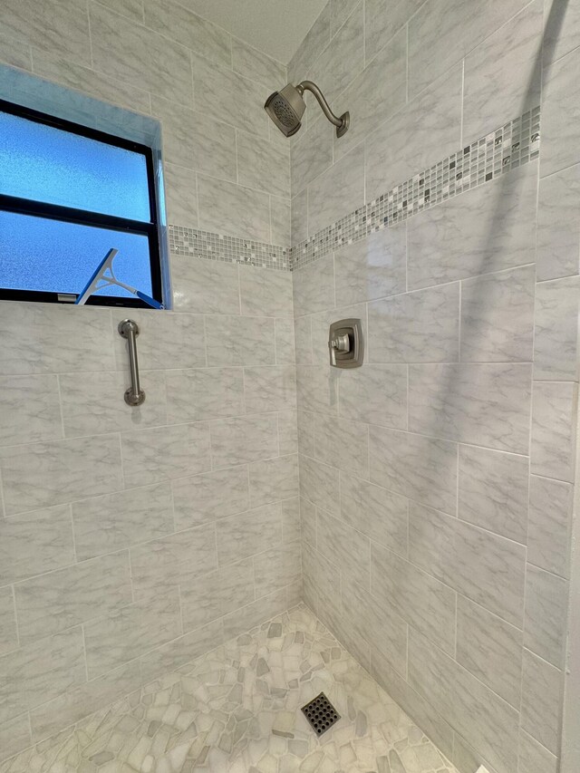 bathroom with a tile shower