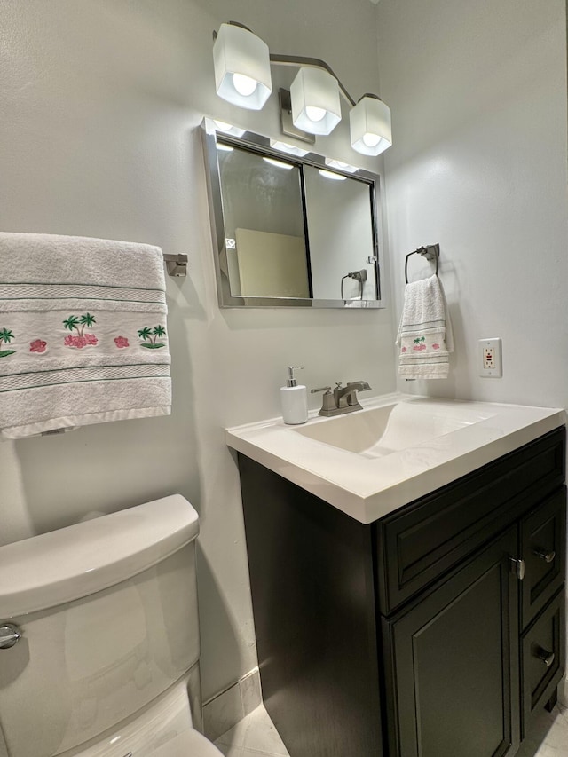 bathroom with tile patterned floors, vanity, and toilet