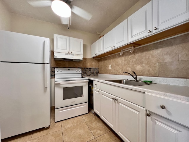 kitchen with white appliances, sink, tasteful backsplash, light tile patterned flooring, and white cabinetry