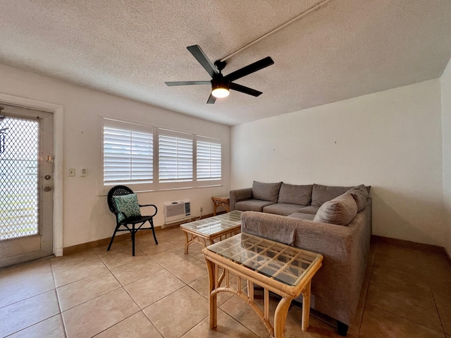 tiled living room featuring ceiling fan, a textured ceiling, and a wall mounted AC