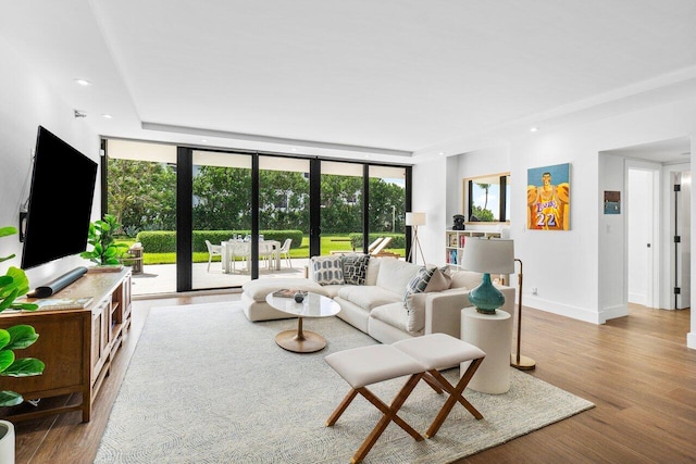 living room with expansive windows and hardwood / wood-style flooring