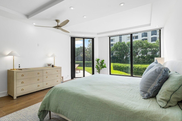 bedroom with ceiling fan, access to exterior, and light wood-type flooring