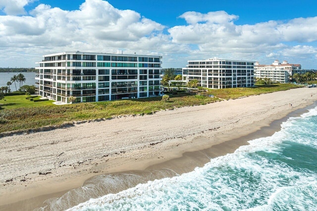 view of building exterior with a view of the beach and a water view