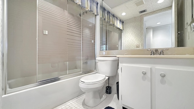 full bathroom featuring toilet, vanity, shower / bath combination with glass door, and tile patterned flooring