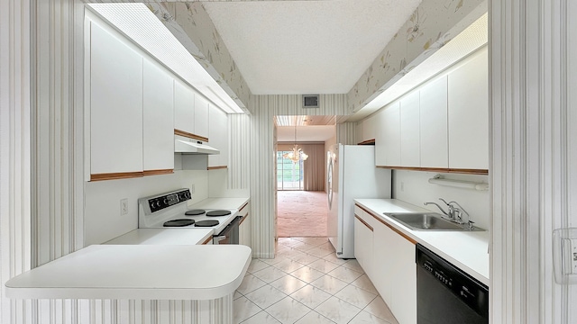 kitchen with white appliances, sink, white cabinets, light tile patterned floors, and a chandelier