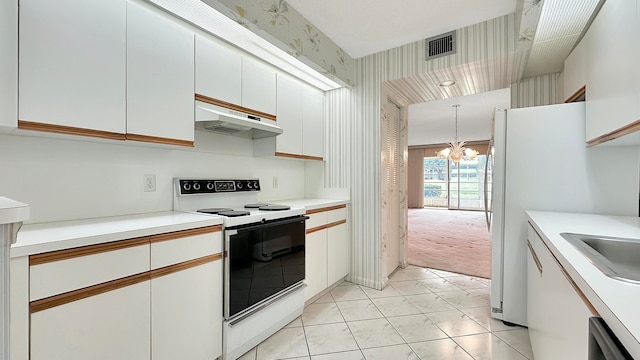 kitchen featuring a chandelier, light carpet, white cabinets, and white appliances