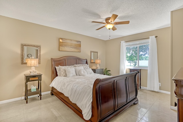 bedroom featuring ceiling fan, a textured ceiling, and light tile patterned flooring