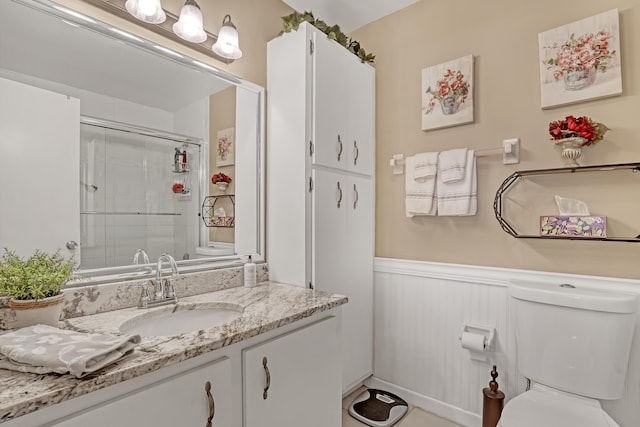 bathroom featuring vanity, toilet, and walk in shower