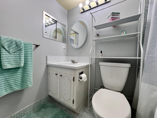 full bath with tile patterned flooring, vanity, toilet, and baseboards