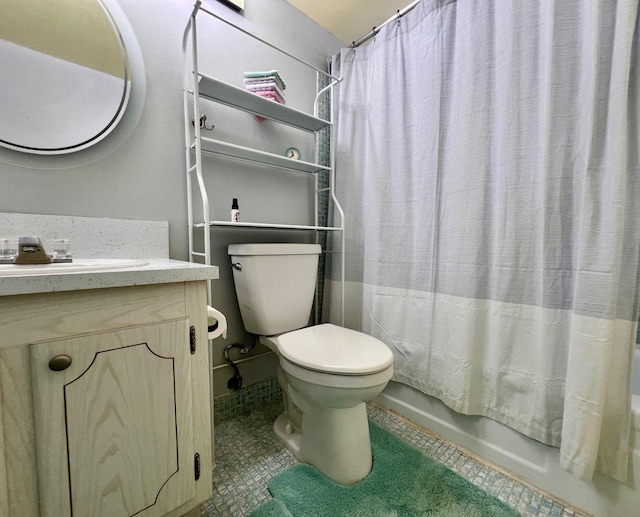 bathroom with shower / bath combo with shower curtain, tile patterned flooring, vanity, and toilet