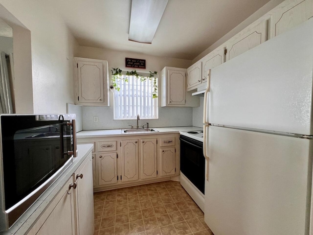 kitchen featuring light countertops, white appliances, a sink, and under cabinet range hood