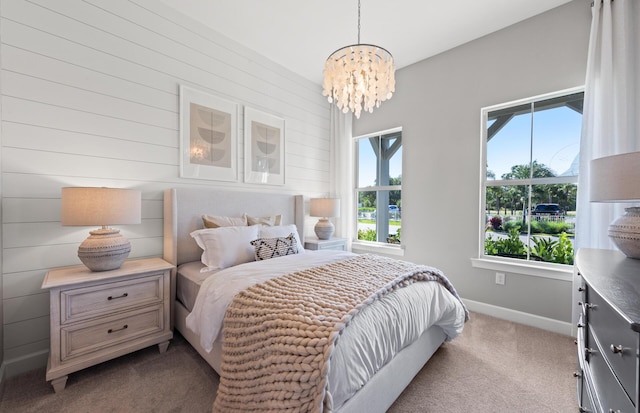 bedroom featuring an inviting chandelier, carpet, and baseboards