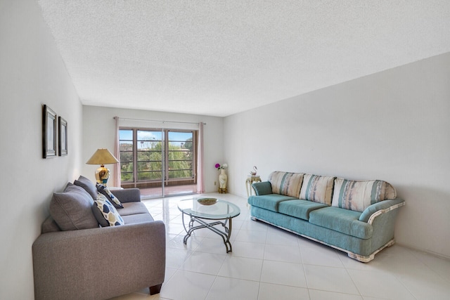 living room featuring a textured ceiling and light tile patterned floors