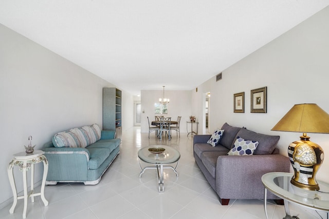 tiled living room with a notable chandelier