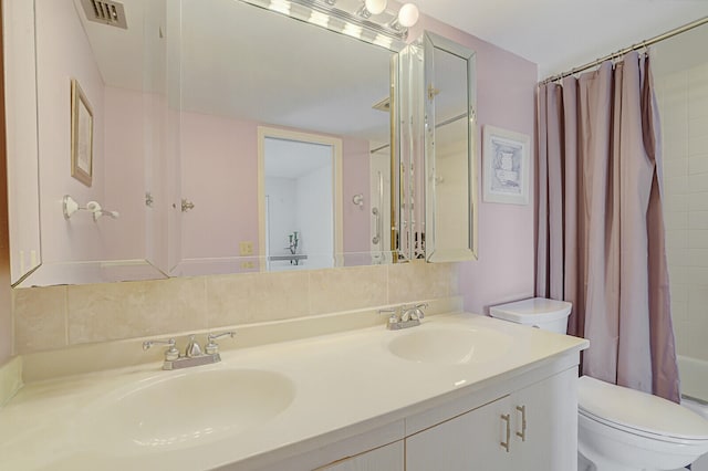 full bathroom with toilet, vanity, and shower / bathtub combination with curtain