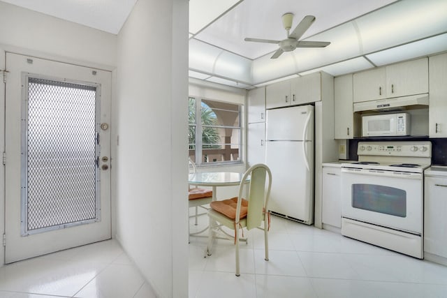 kitchen featuring ceiling fan, cream cabinets, light tile patterned floors, and white appliances