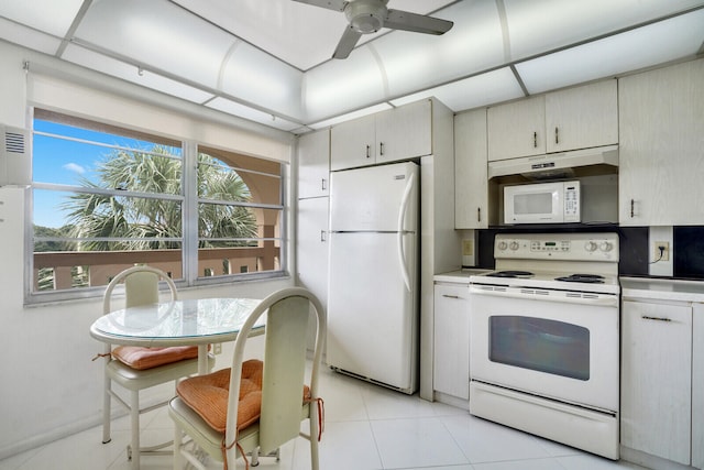 kitchen with ceiling fan, light tile patterned floors, and white appliances