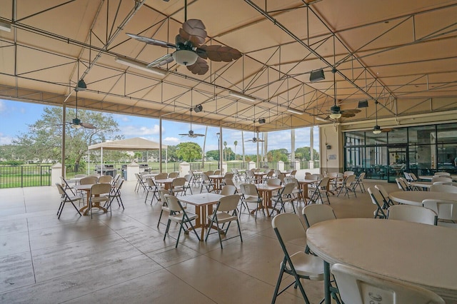 dining area with expansive windows and ceiling fan