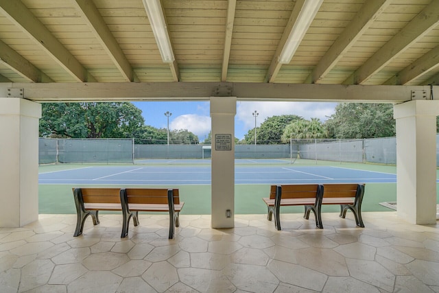 view of community featuring tennis court