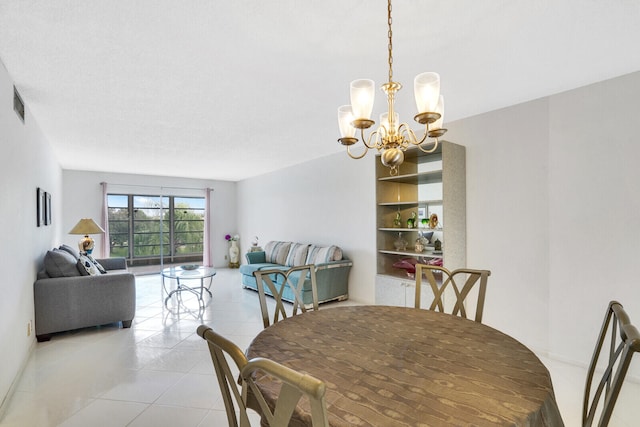 tiled dining area with an inviting chandelier