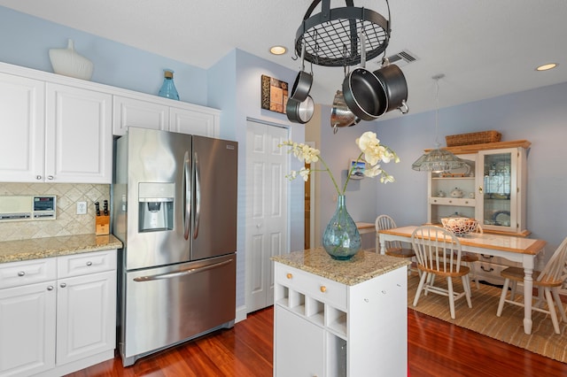 kitchen featuring stainless steel fridge with ice dispenser, backsplash, dark wood finished floors, white cabinetry, and recessed lighting