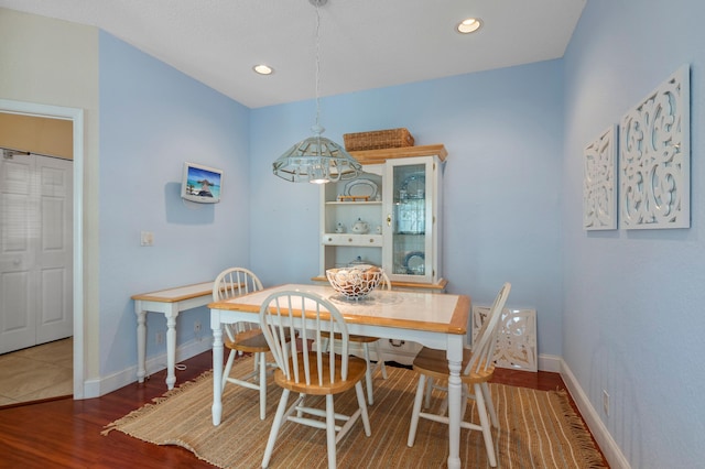 dining room with wood finished floors, baseboards, and recessed lighting