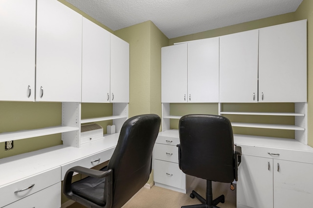 office featuring built in study area and a textured ceiling