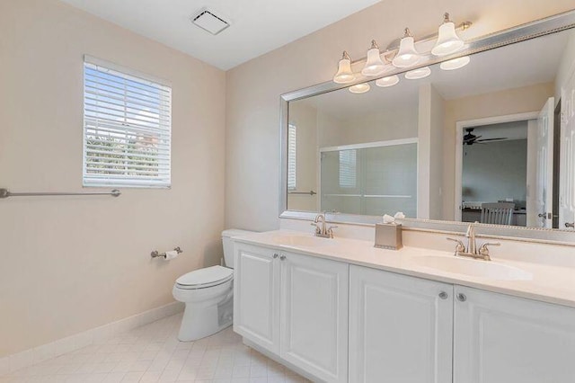 bathroom with toilet, walk in shower, vanity, and ceiling fan