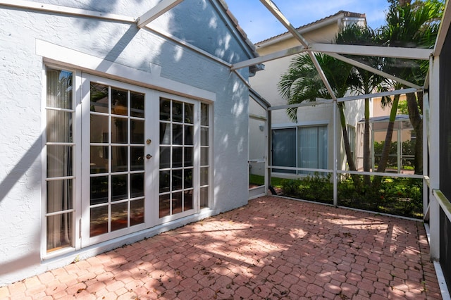 unfurnished sunroom with french doors