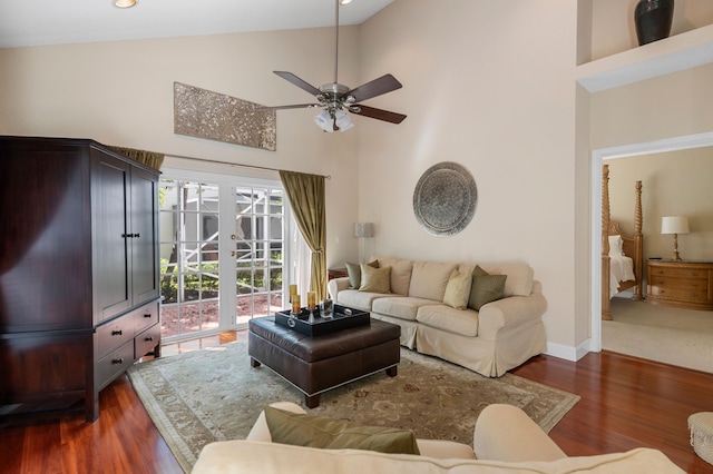 living room featuring dark hardwood / wood-style floors, high vaulted ceiling, and ceiling fan