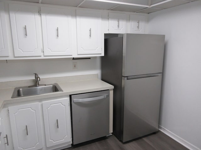 kitchen featuring dark hardwood / wood-style floors, white cabinets, appliances with stainless steel finishes, and sink