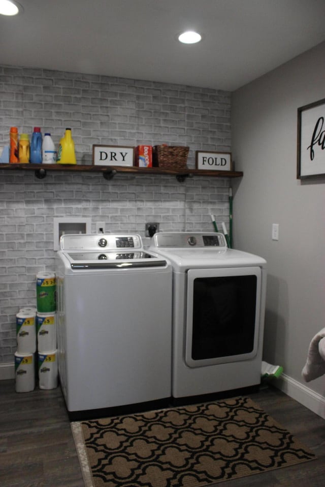 kitchen featuring brick wall and fridge