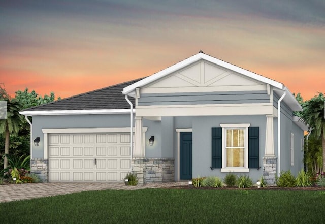10574 Northbrook Cir Unit Prestige 049, Palm Beach Gardens, FL 33412 - view of front facade with stone siding, an attached garage, a yard, and stucco siding