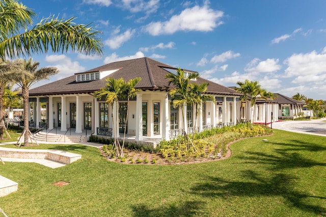 10574 Northbrook Cir Unit Prestige 049, Palm Beach Gardens, FL 33412 - rear view of property with a yard, covered porch, roof with shingles, and stucco siding