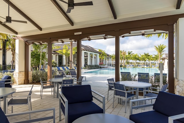 10574 Northbrook Cir Unit Prestige 049, Palm Beach Gardens, FL 33412 - view of patio / terrace with outdoor dining space, a ceiling fan, and a community pool