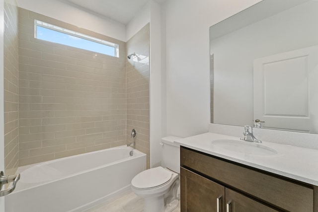 full bathroom with tiled shower / bath, vanity, and toilet