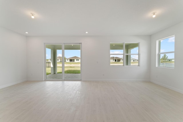 spare room featuring light hardwood / wood-style floors