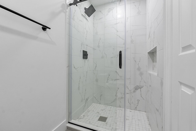 bathroom with a shower with door