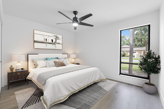 bedroom with light hardwood / wood-style flooring and ceiling fan