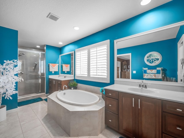 bathroom featuring tile patterned flooring, vanity, a textured ceiling, and independent shower and bath