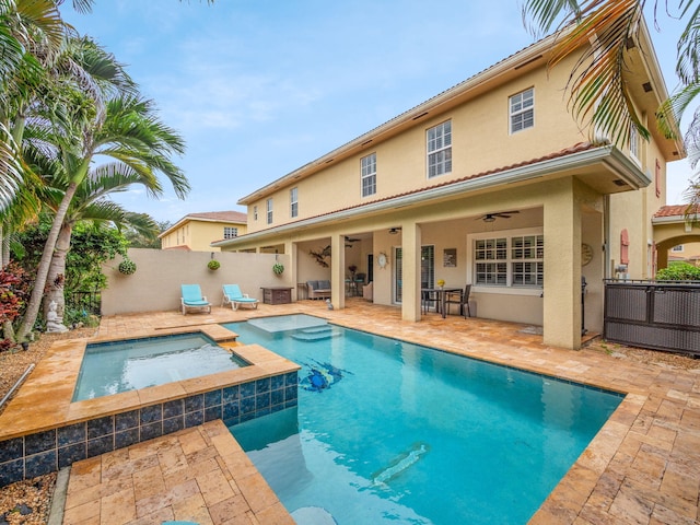 view of swimming pool with an in ground hot tub, ceiling fan, and a patio