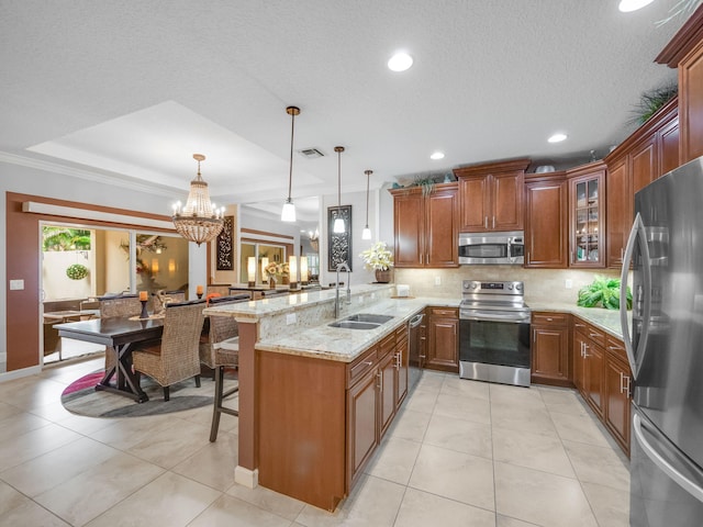 kitchen featuring sink, hanging light fixtures, stainless steel appliances, a kitchen breakfast bar, and crown molding