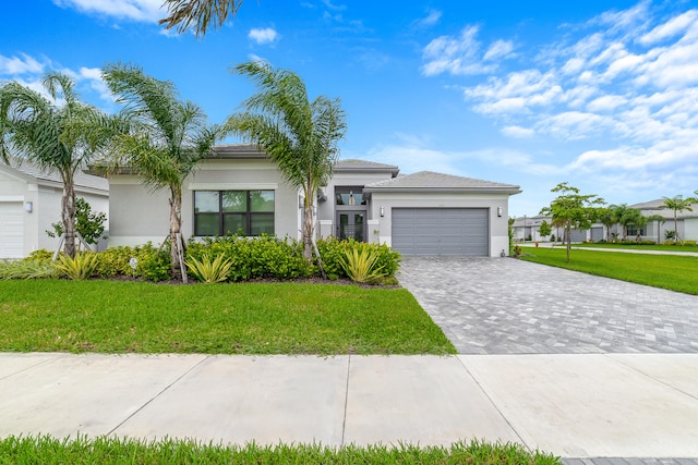 view of front of house with a front yard and a garage