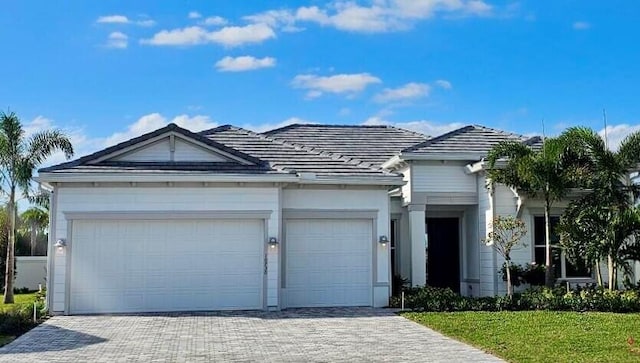 single story home with a front yard and a garage