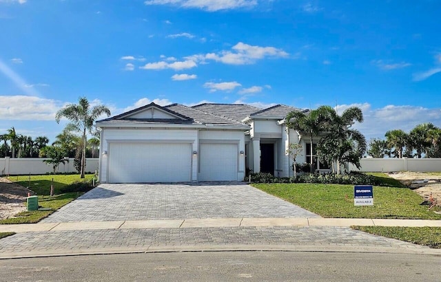 view of front of home with a garage and a front yard