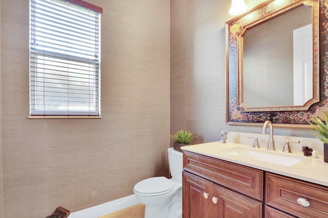 bathroom featuring toilet and vanity